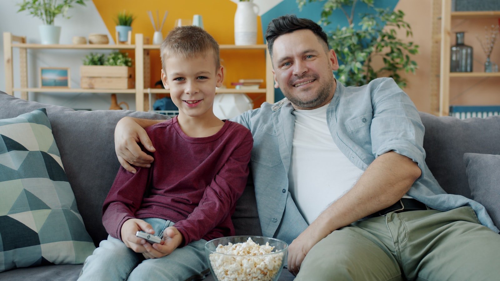 Father and son watching a movie together at home